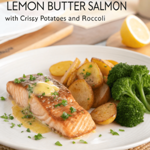 A beautifully plated dish of lemon butter salmon garnished with parsley, accompanied by crispy golden potatoes and bright green broccoli, arranged on a white plate with a light, elegant background.